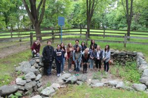 students posing in a stone pit.