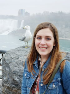 Emma Rarich standing in front of a seagull. 